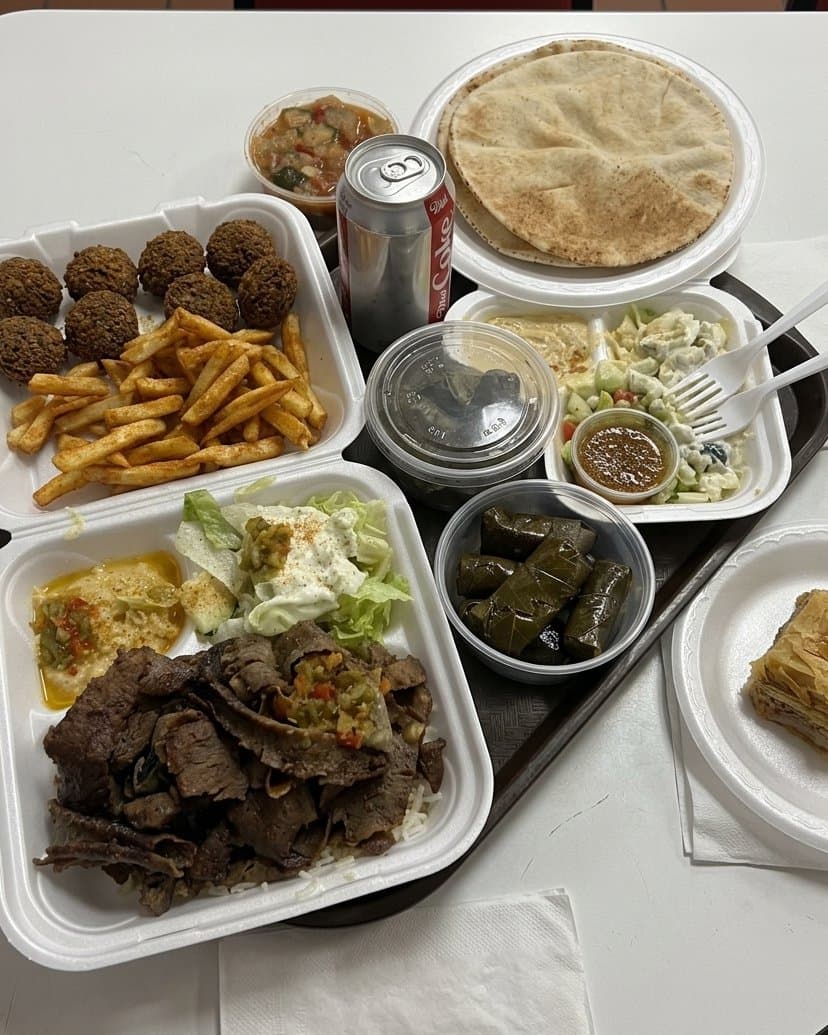 Signature Mediterranean Bowl with grilled meats, fresh vegetables, and rice at Leena's Food